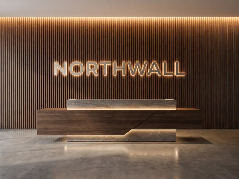 Illustration: brushed letters reading NORTHWALL on a walnut slat wall behind a reception desk