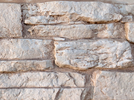 Close-up of a stone wall with varying stone sizes and colors.